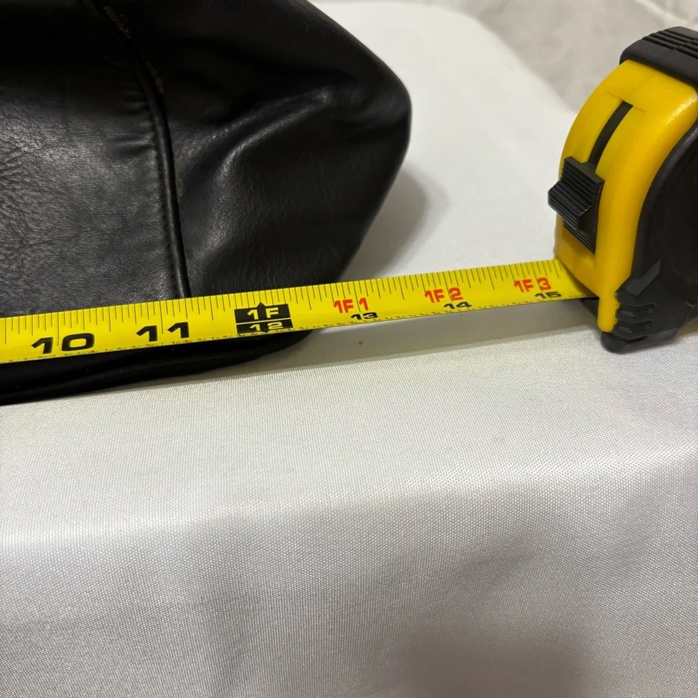 Black tote bag with a tassel accent. - Picture 10 of 12